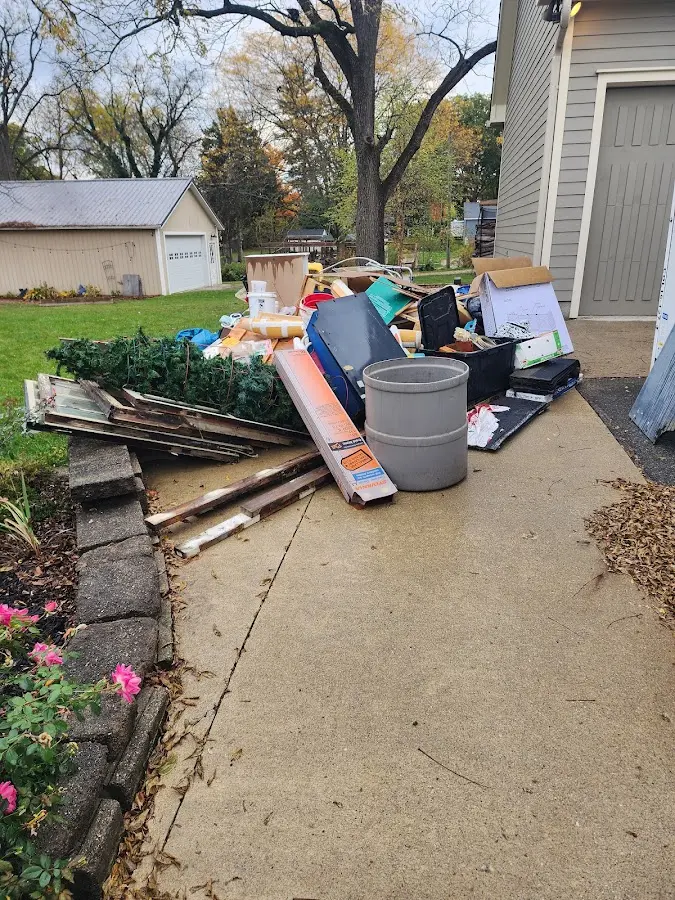 Dumpster being loaded with debris for Estate Cleanout Dumpster Rental in Kansas City